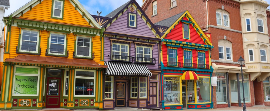 Colorful storefronts featuring a mix of orange, purple, and red buildings with unique architectural details.